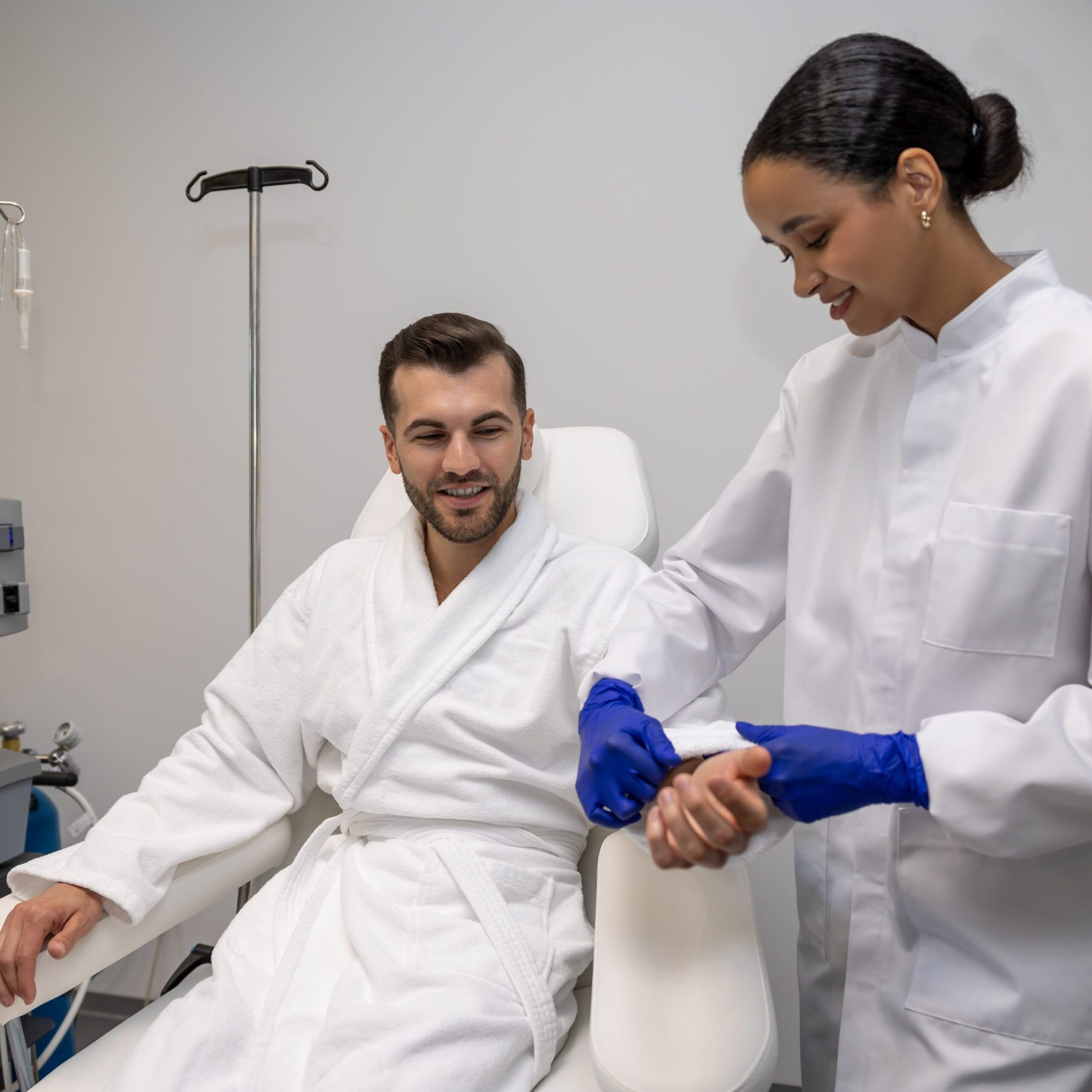 Bearded man in modern wellness center during intravenous vitamin therapy.